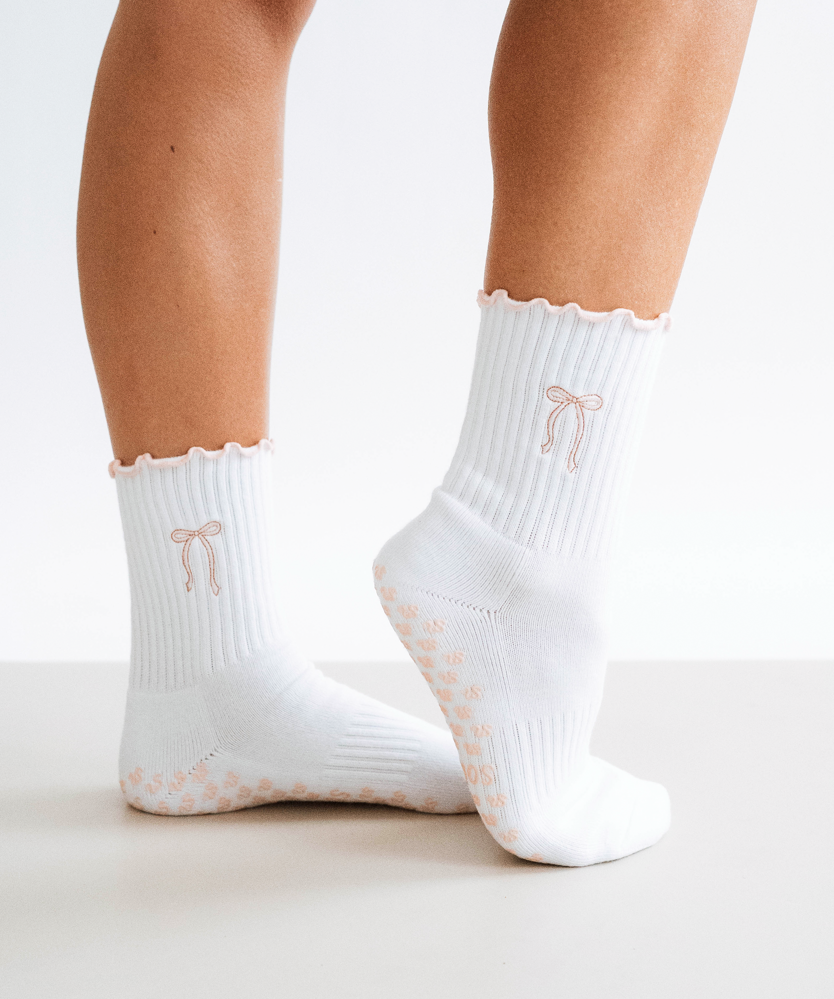 White crew grip socks with baby pink bow design